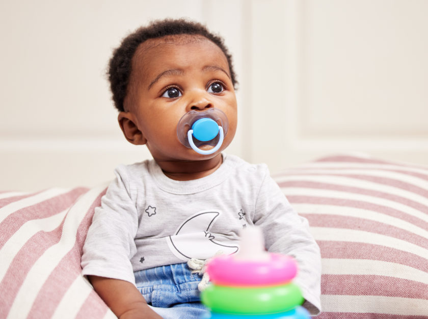 infant with pacifier.