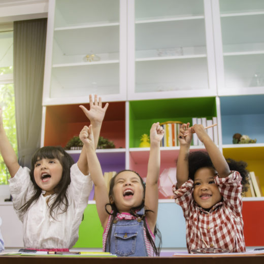 group of children raising arms.