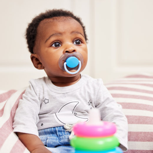 infant with pacifier.